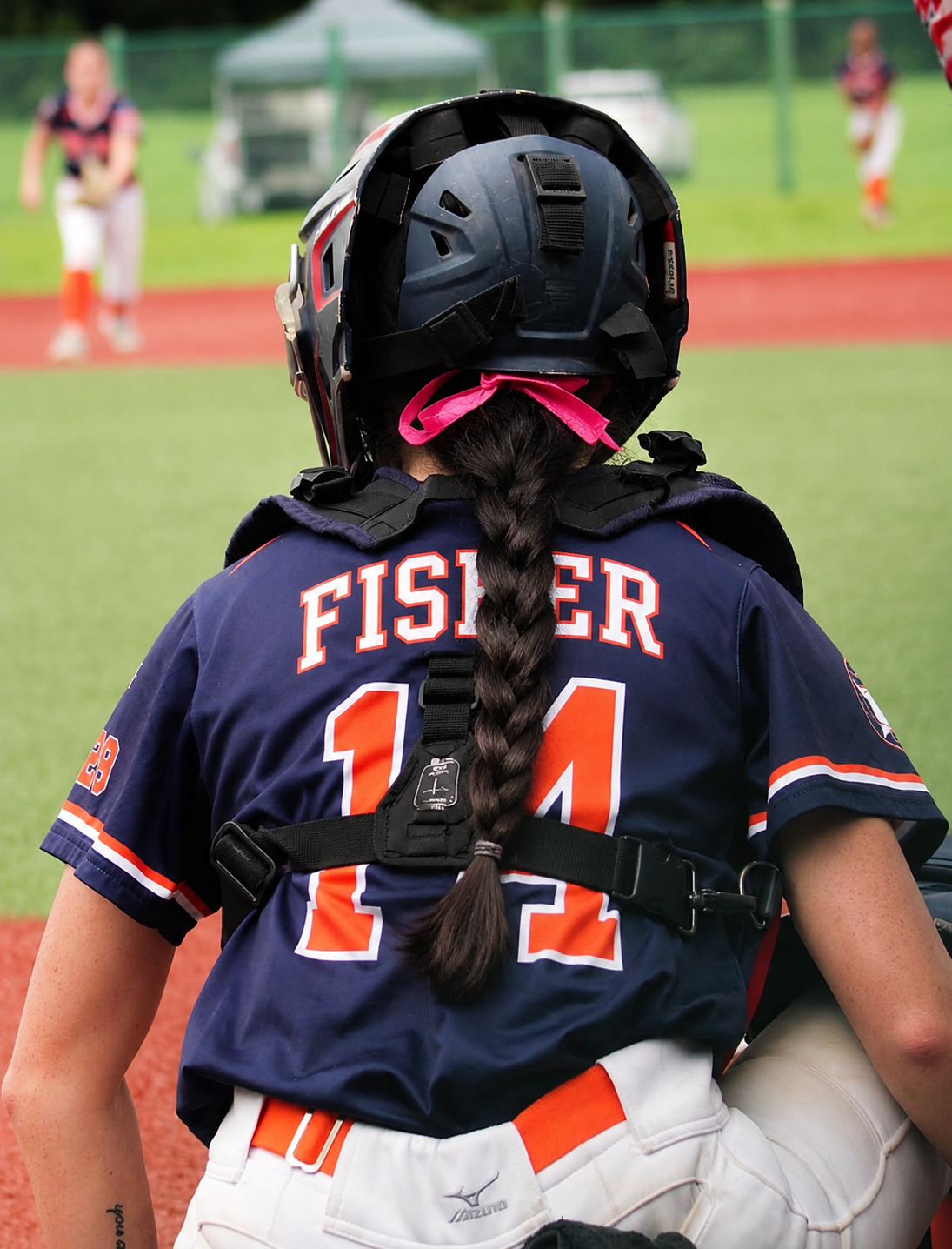 Jade Fisher — behind the plate in catcher's gear with Fisher 14 jersey
